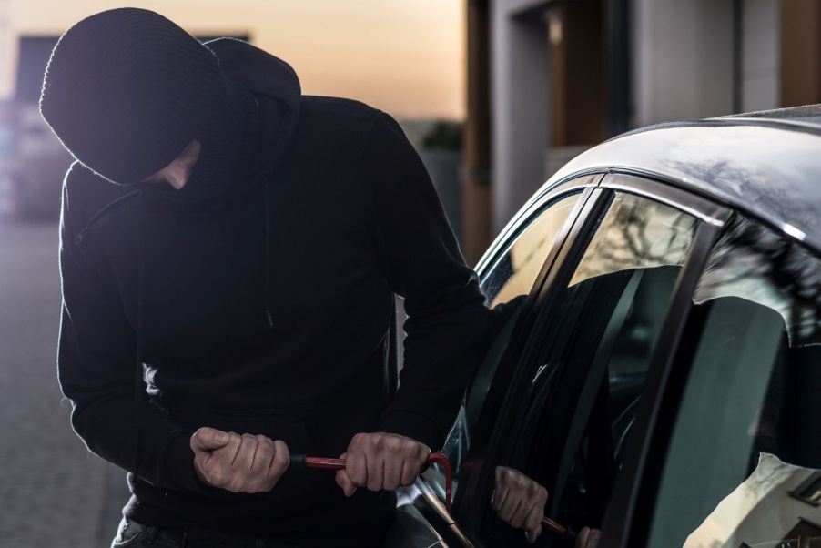 A person trying to break into a car