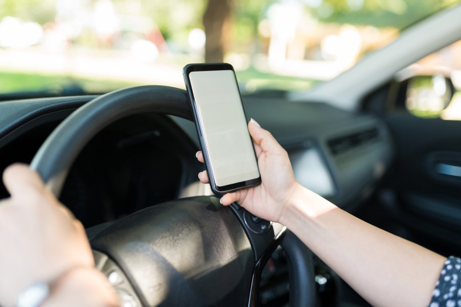 A woman texting while driving