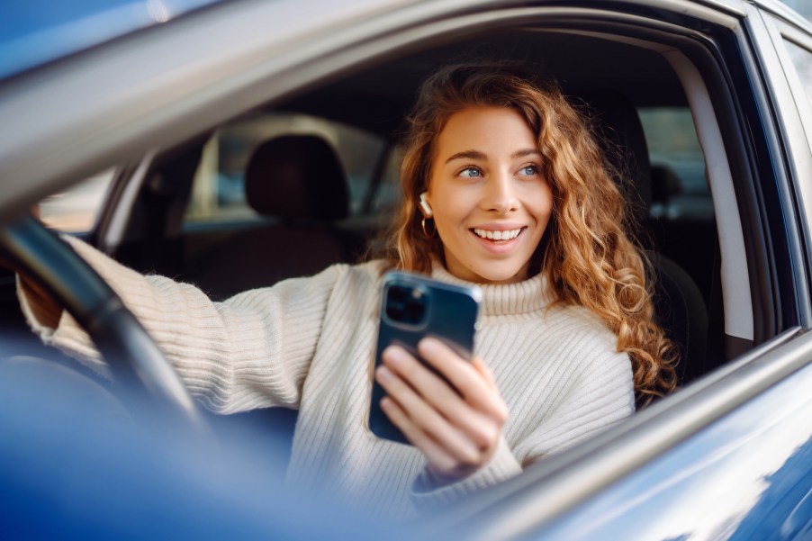 A woman driving with AirPods