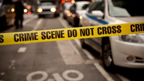 Yellow crime scene tape in front of road