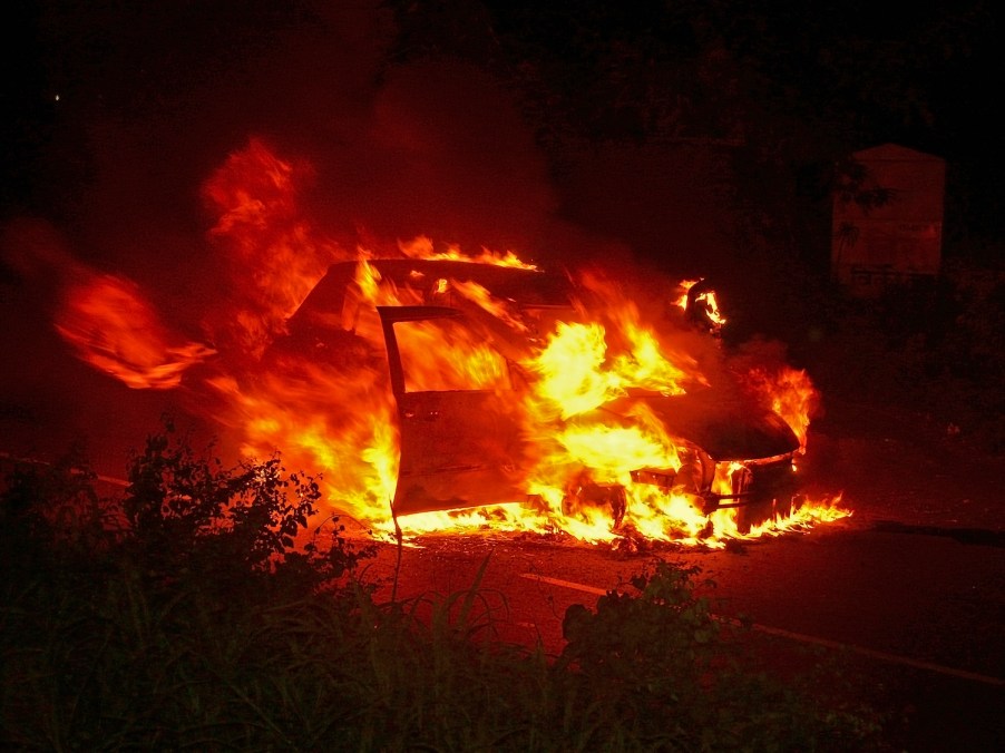 An SUV burning at night