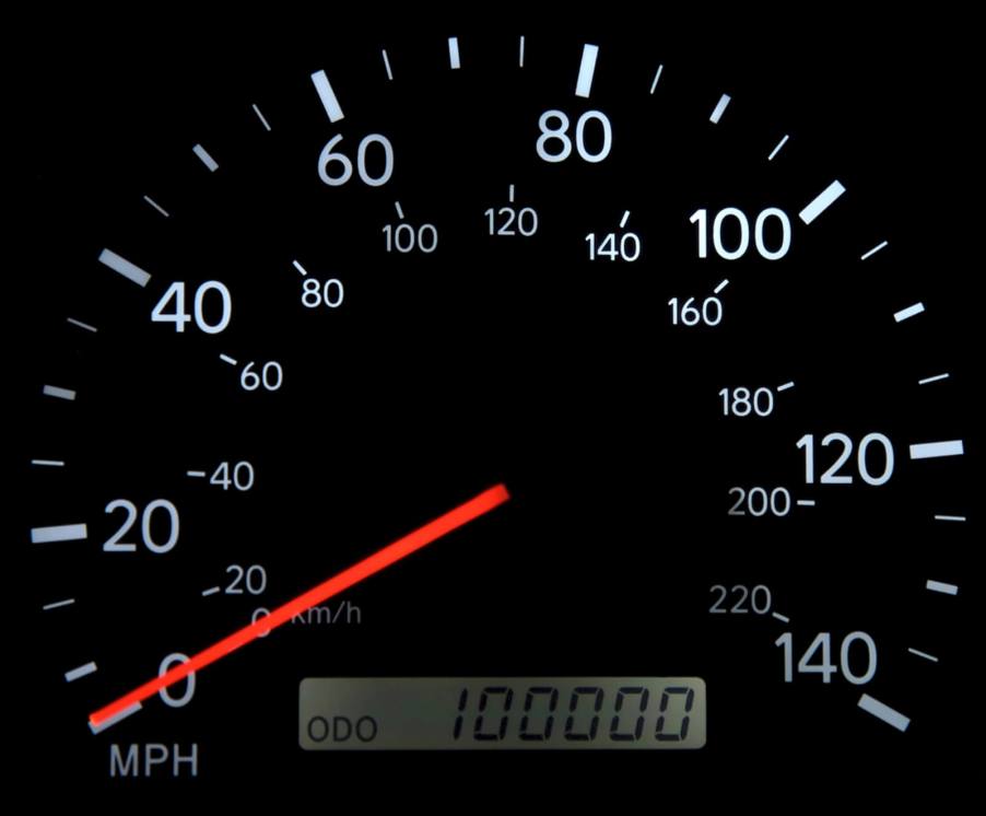 A gauge shows a car with 100K miles, which some buyers consider bad and worth avoiding.