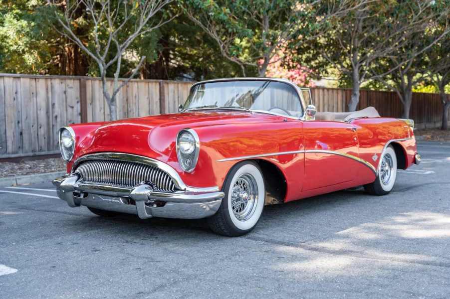 A bright red 1954 Buick Skylark convertible parked in full left front angle view