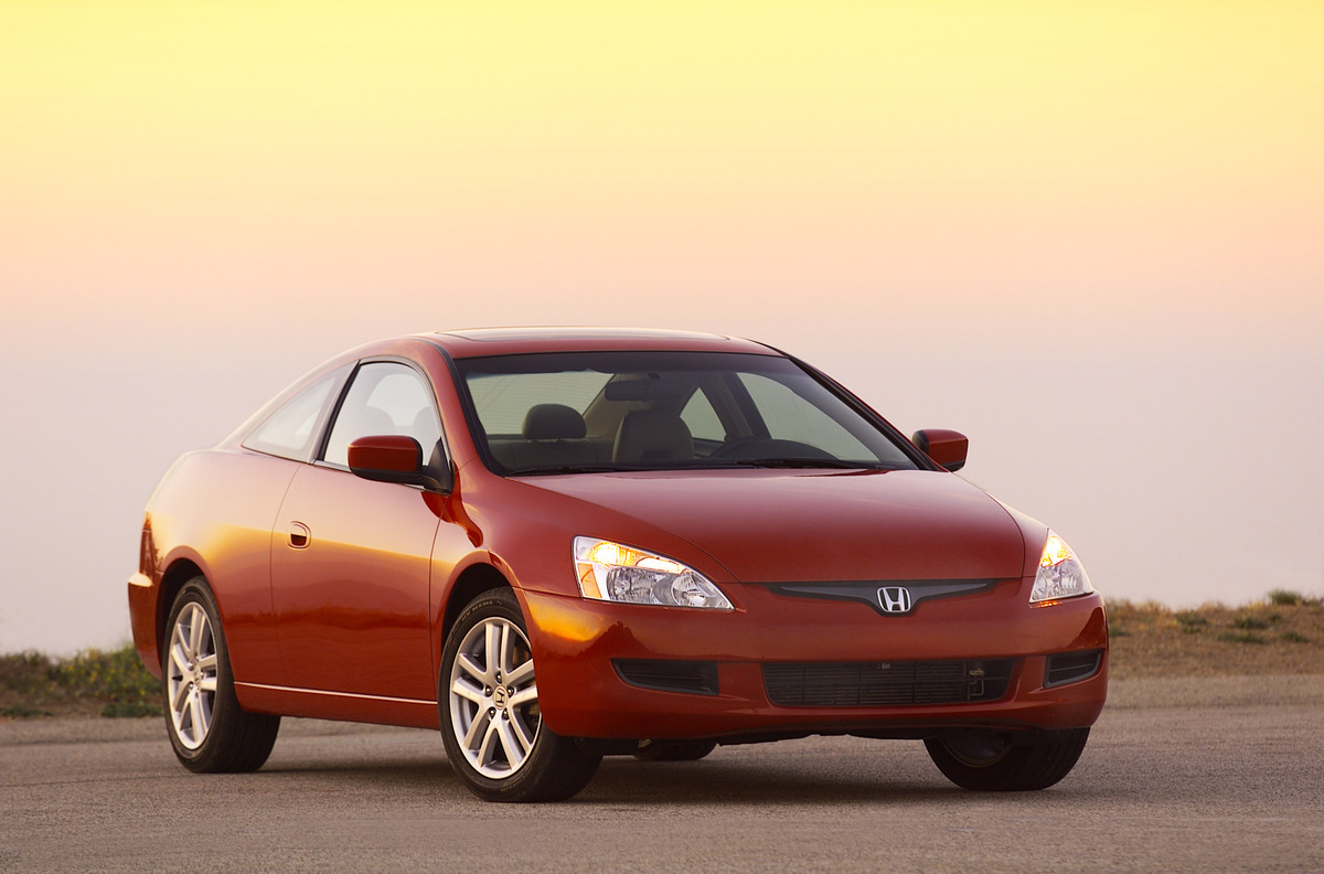 A red 2003 Honda Accord parked outside at dusk in right front angle view