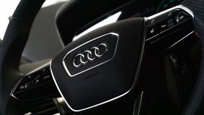 The audi logo on the black steering wheel of a recalled crossover SUV.