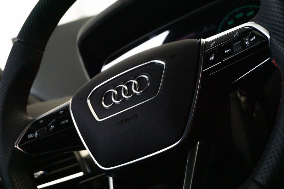 The audi logo on the black steering wheel of a recalled crossover SUV.