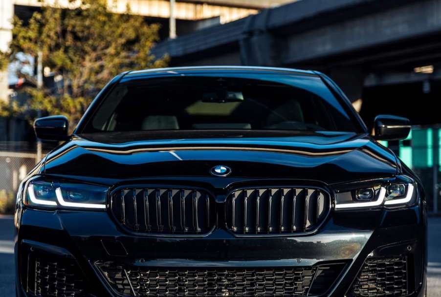 The grille of a black BMW tailgating another car.