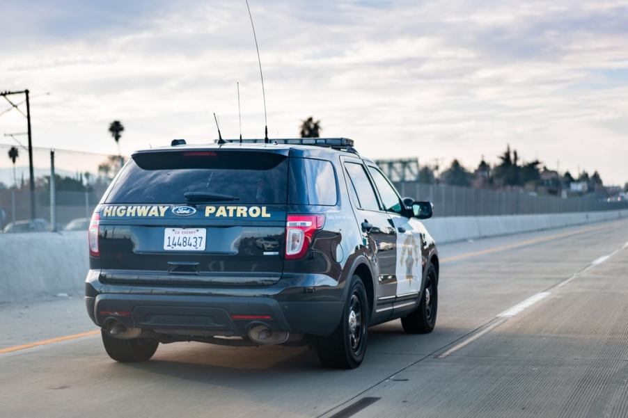 A California Highway Patrol Ford Police Interceptor SUV on a highway.
