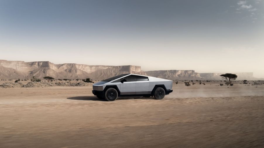 A Tesla Cybertruck driving through the desert.