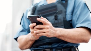 Police officer reading phone with mDL mobile driver's license app, during traffics top.