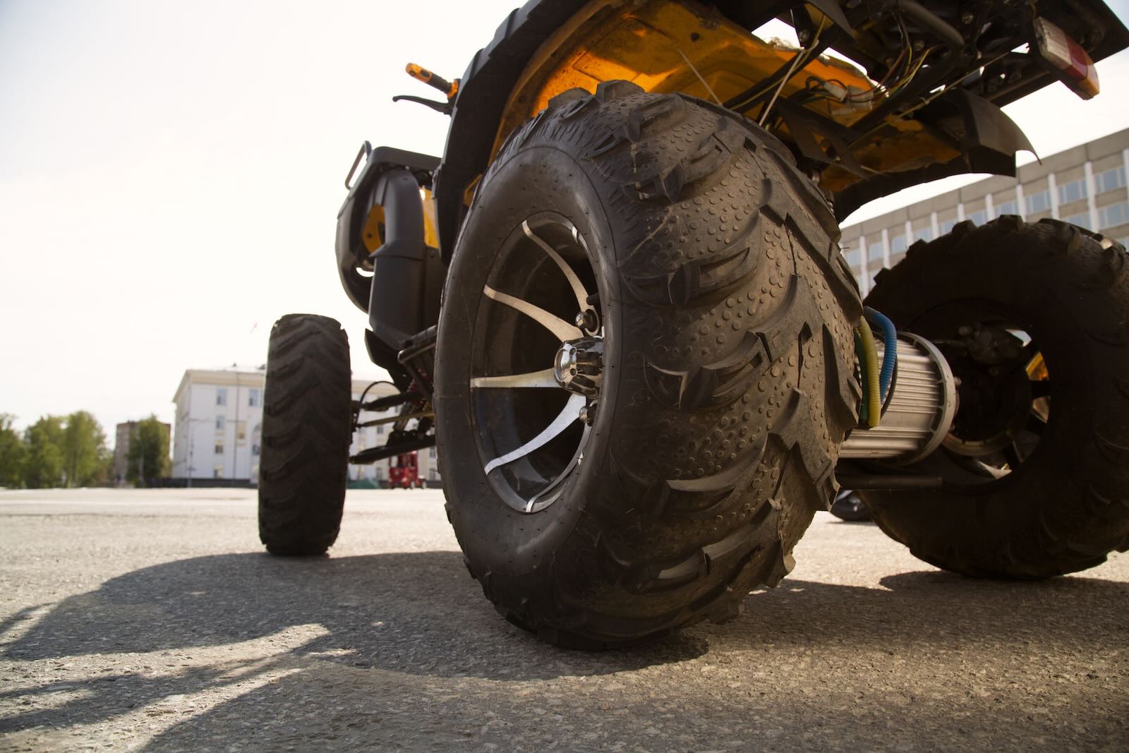 Michigan man on a stolen four-wheeler drives up to the Chrysler Stellantis headquarters, office building in the background.