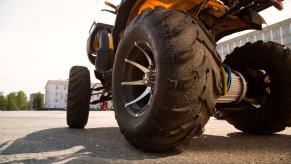Michigan man on a stolen four-wheeler drives up to the Chrysler Stellantis headquarters, office building in the background.