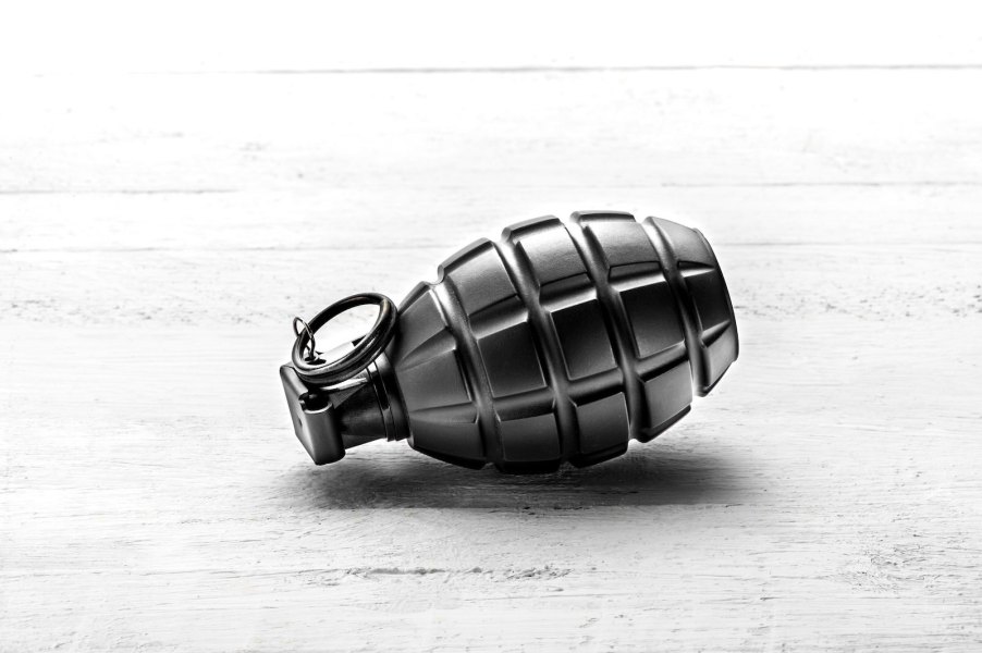 Black antique grenade abandoned on white sidewalk after a car break-in in Nebraska