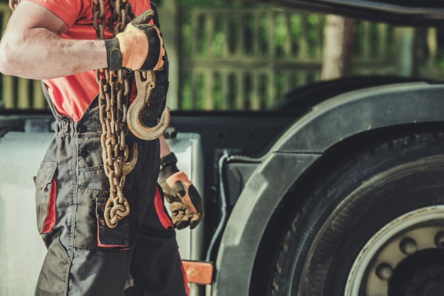 Tow truck driver moving a residents car for the HOA head