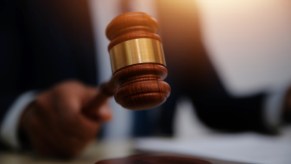 Judge bangs a gavel during a court proceeding, ordering Los Angeles woman to pay fine for stolen Hyundai Elantra car