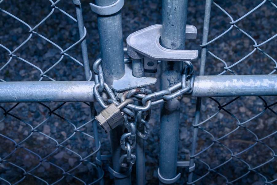 A image shows a locked gate, like the one at a car meet where San Francisco cops locked up cars and drivers to look for stolen cars.