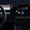 A screen shows Tesla Autopilot in action.