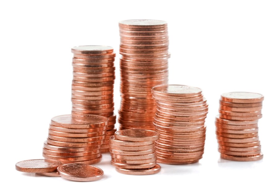 Huge stack of pennies used to pay a toll, sitting on a white background