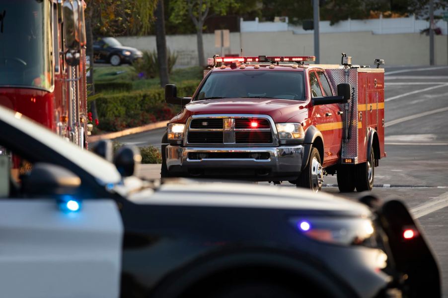 The hood of a police cruiser parking in fire trucks and other emergency vehicles.