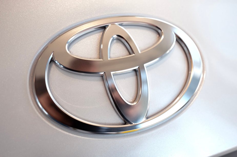 Logo of Toyota on a vintage Previa minivan with a supercharged, mid-engine, AWD configuration