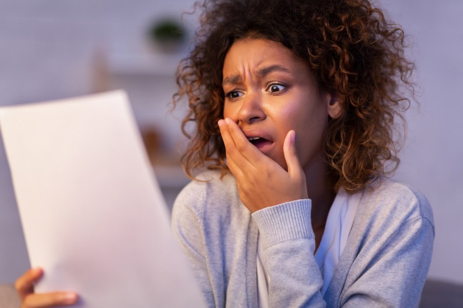 Shocked woman reads a letter from Enterprise alleging she committed Grand Theft Auto