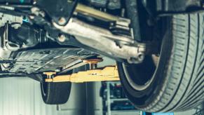 A car's underside view on a mechanic's lift