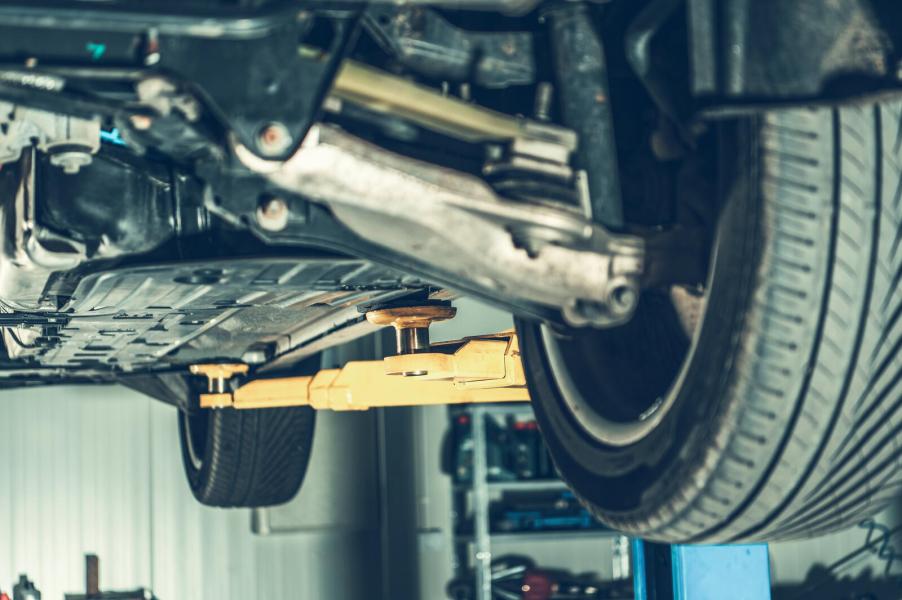 A car's underside view on a mechanic's lift