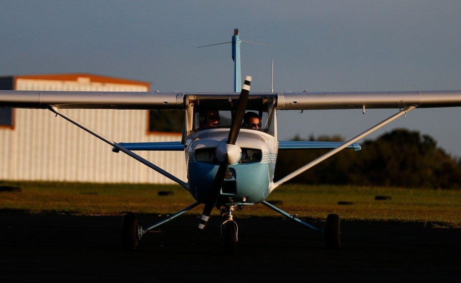 A Cessna 150 airplane on the ground facing the viewer
