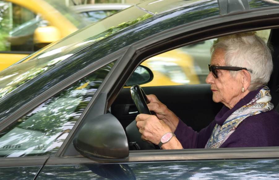 An elderly driver hits the road in a small hatchback.