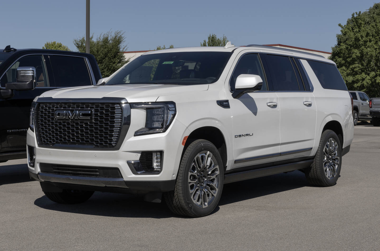 A white GMC Yukon Denali parked in left front angle view