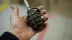 A man holding a grenade in his hand