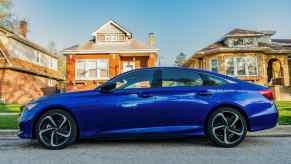 A blue 2020 Honda Accord parallel parked in full left profile view