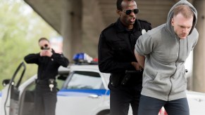 Two police officers arresting a man