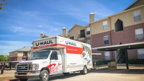 A U-Haul truck parked in front of an apartment complex