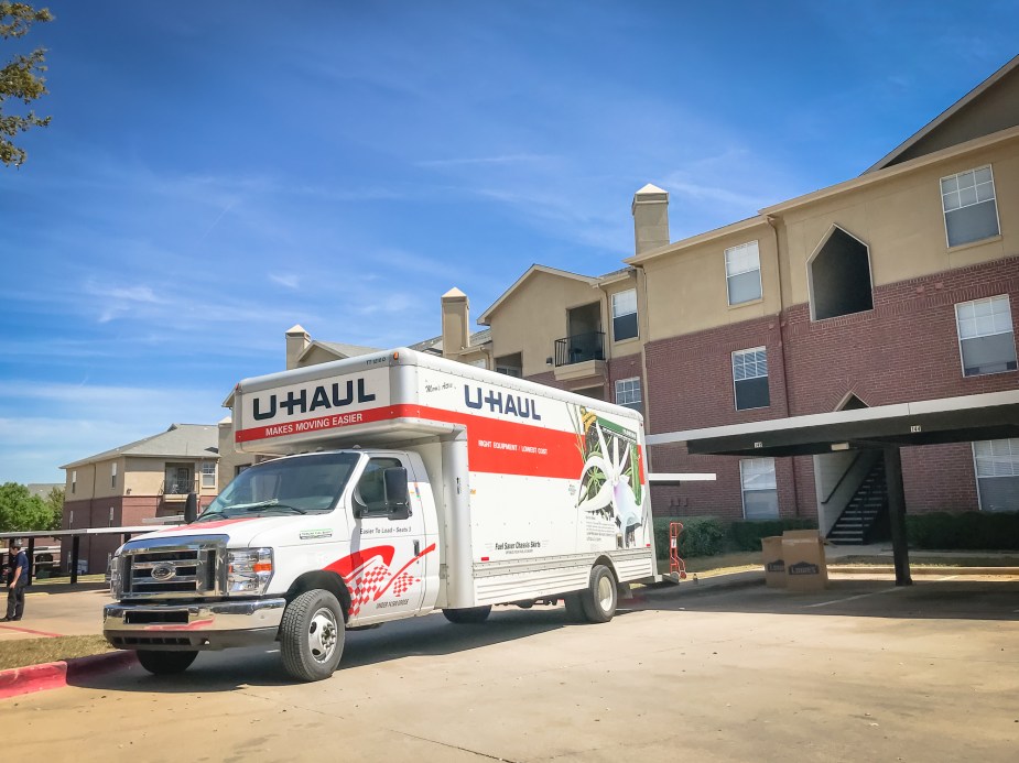 A U-Haul truck parked in front of an apartment complex