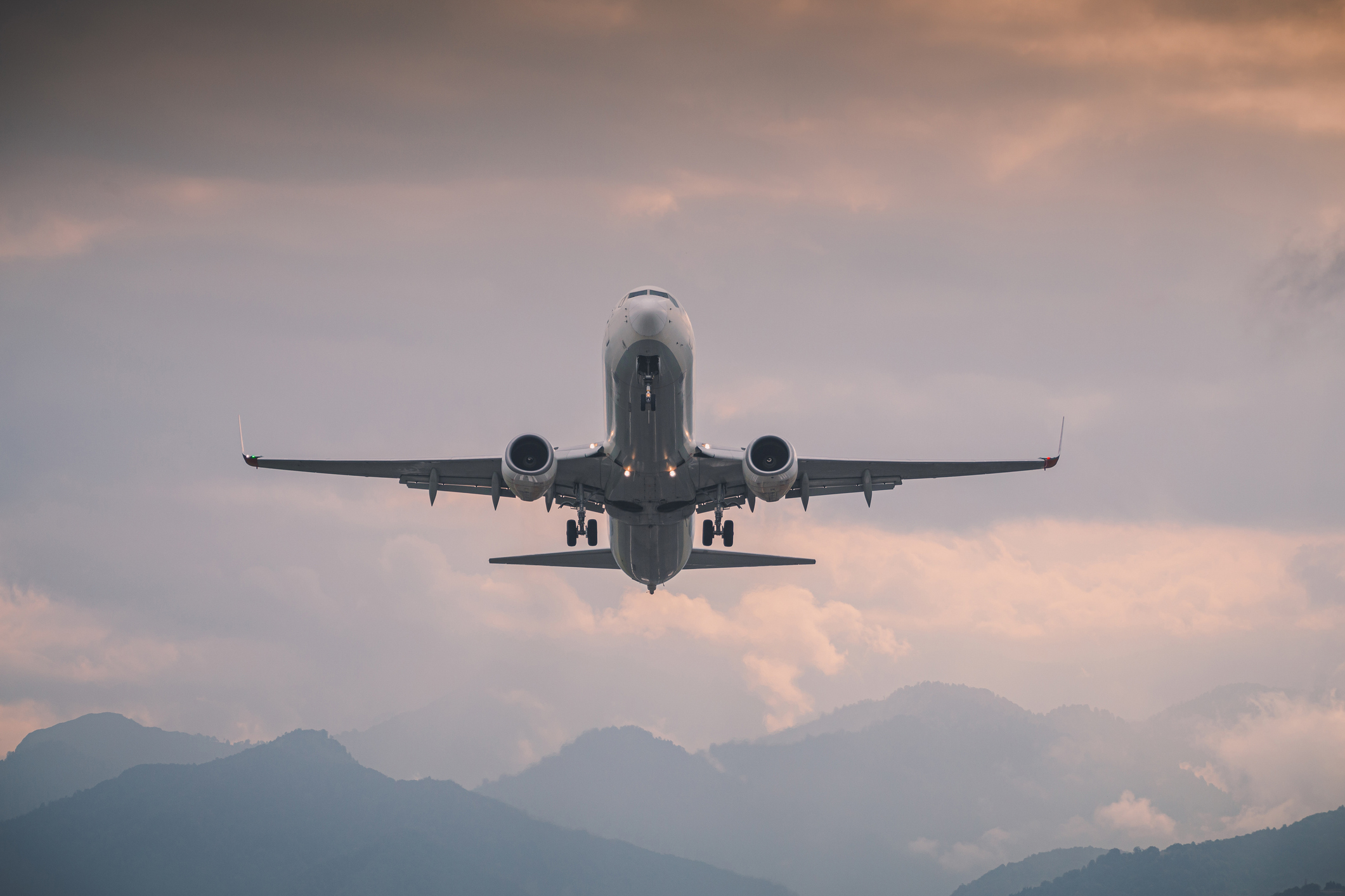 An airplane in the air during sunrise