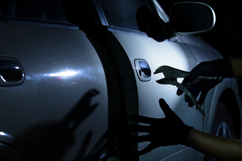 A thief breaking into a truck