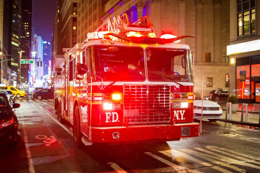 A fire truck in New York City with its lights on