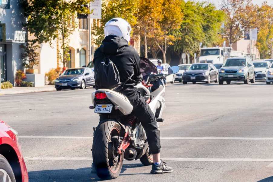 A motorcyclist waiting at a red light