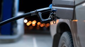 A gas station pump inside a car's fuel neck at night