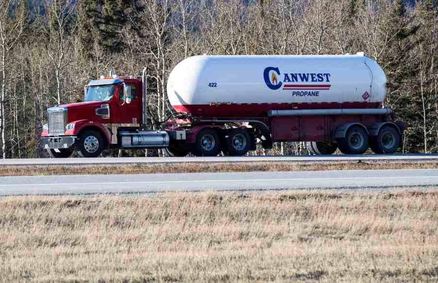 A propane truck driving on the highway