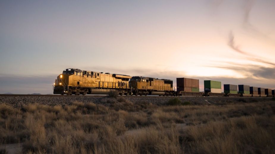 A cargo train engine pulling freight cargo