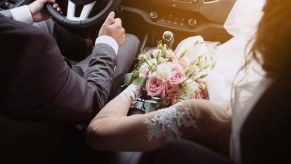 Wedding bride and groom sitting in a car