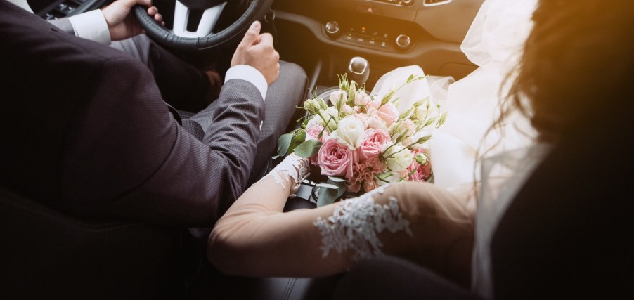 Wedding bride and groom sitting in a car
