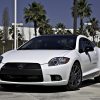 A white 2012 Mitsubishi Eclipse parked outside in left front angle view