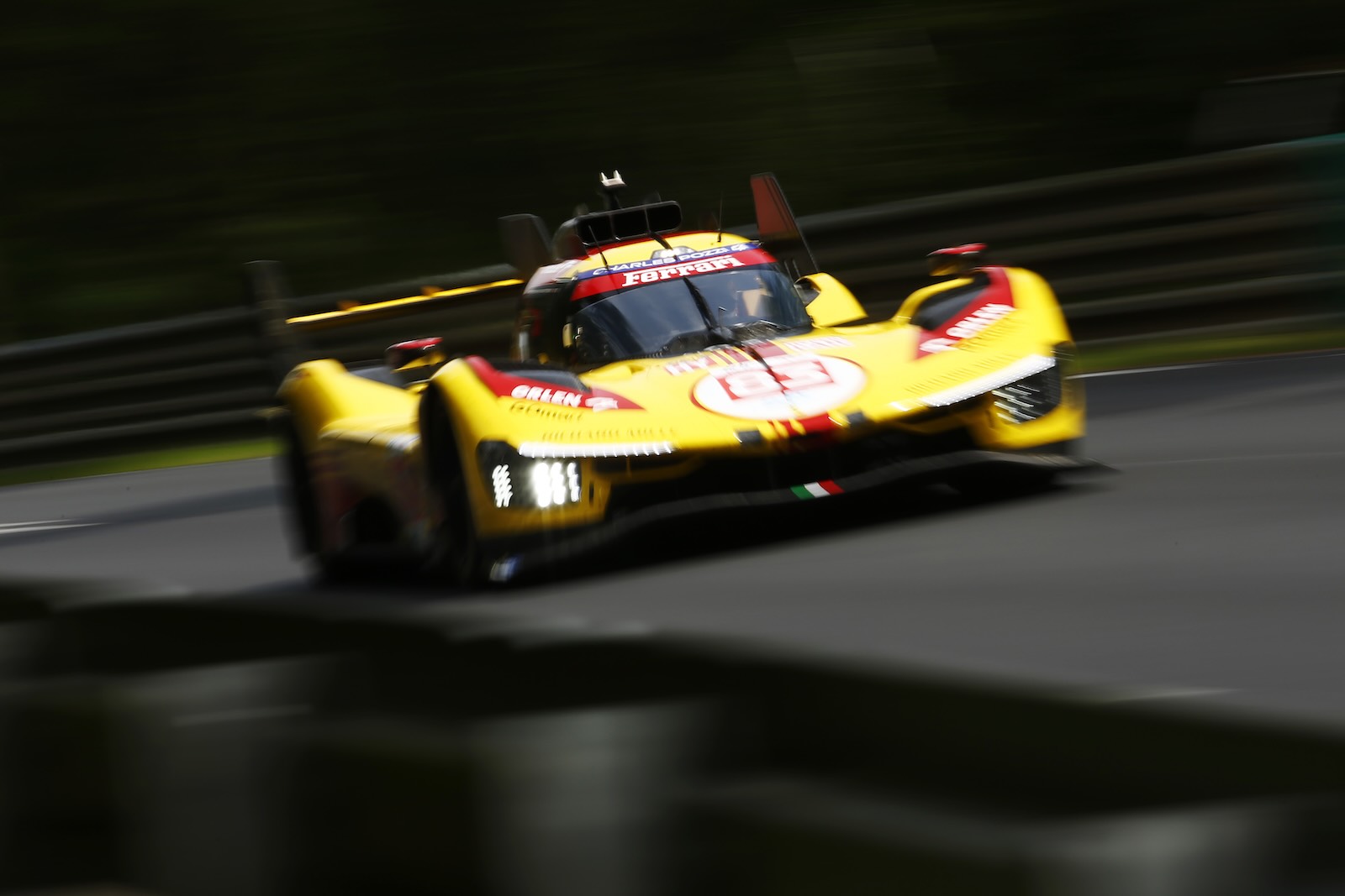 AF Corse's privateer yellow Ferrari hypercar circles the 24 Hours of Le Mans track