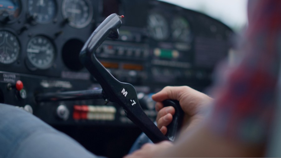 Pilot's hands holding a Cessna 172 yolk during a world record airplane flight.