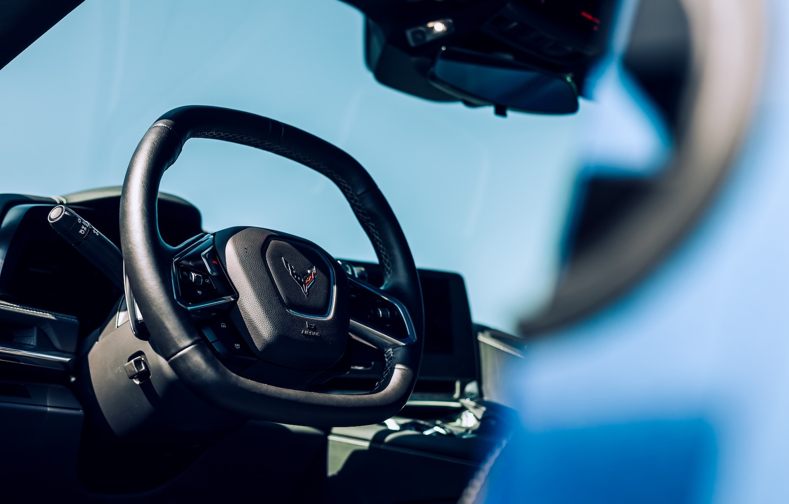 The steering wheel and windshield of a C8 Corvette.