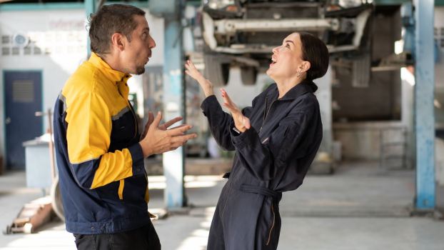 Ducati dealership technicians debate the cost of a Scrambler valve adjustment service