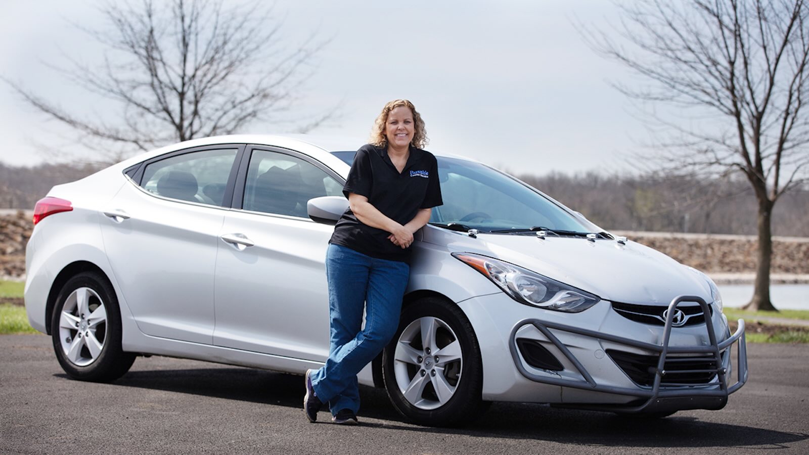 Farrah Haines poses in front of a silver Hyundai Elantra she drove for one million miles.